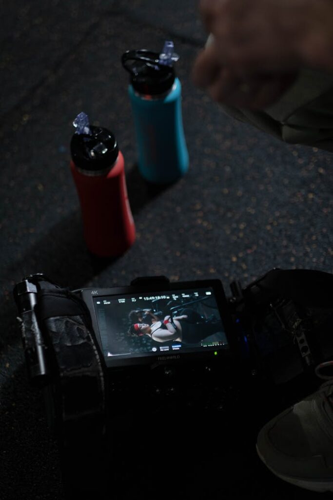 A Video Camera and Sports Bottles on the Floor